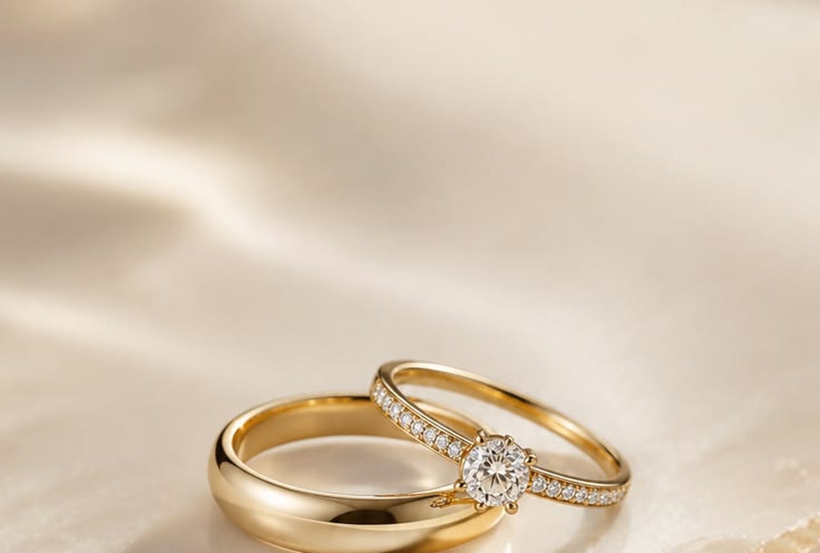 A pair of gold wedding bands on ivory silk