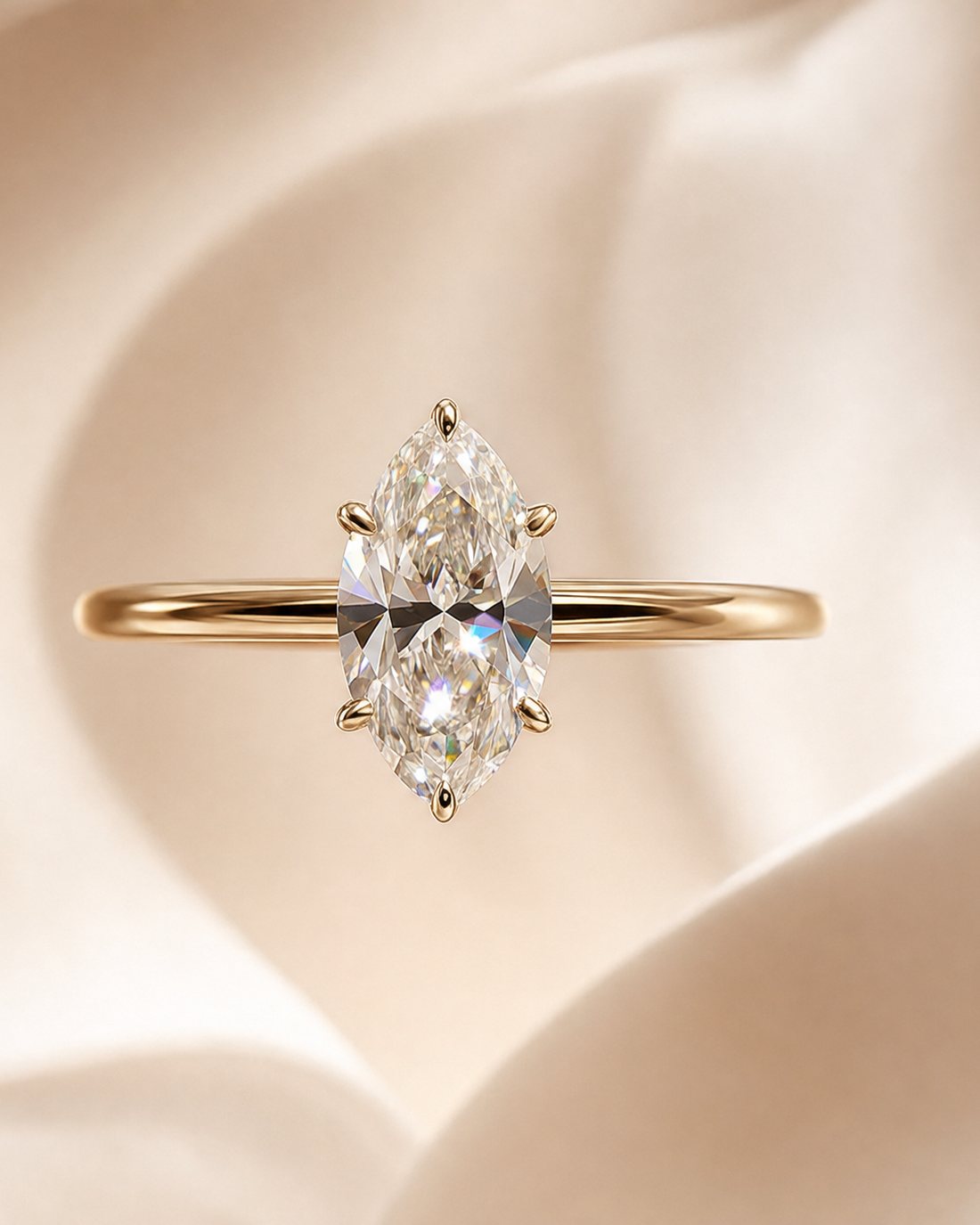 A marquise-cut diamond solitaire in yellow gold, on silk